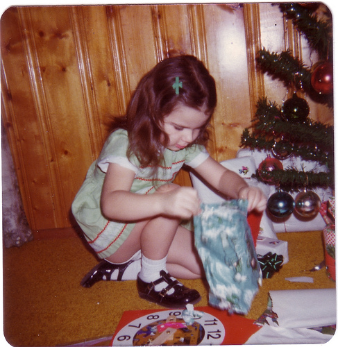 young girl opening christmas presents