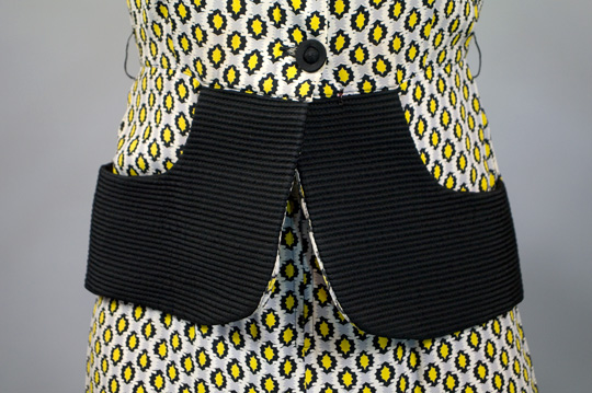 a close up of the peplum of a 1940s suit style dress